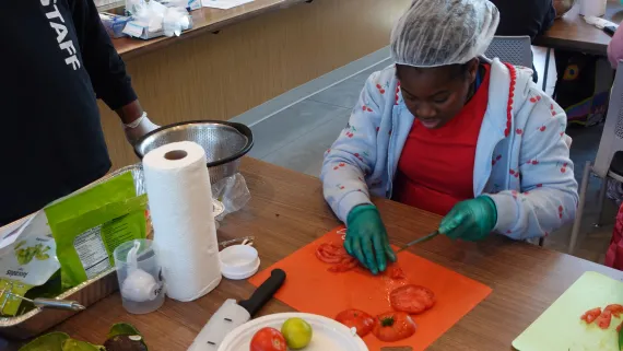 Power Scholars Academy camper learning food education at the Foodlink Community Farm's new kitchen