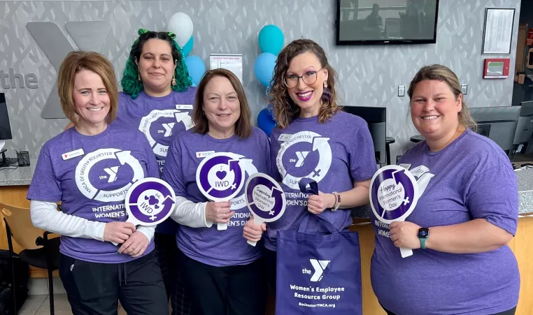 a photo of five ymca staff members who put together the international women's day vendor fair that was held at the westside family ymca