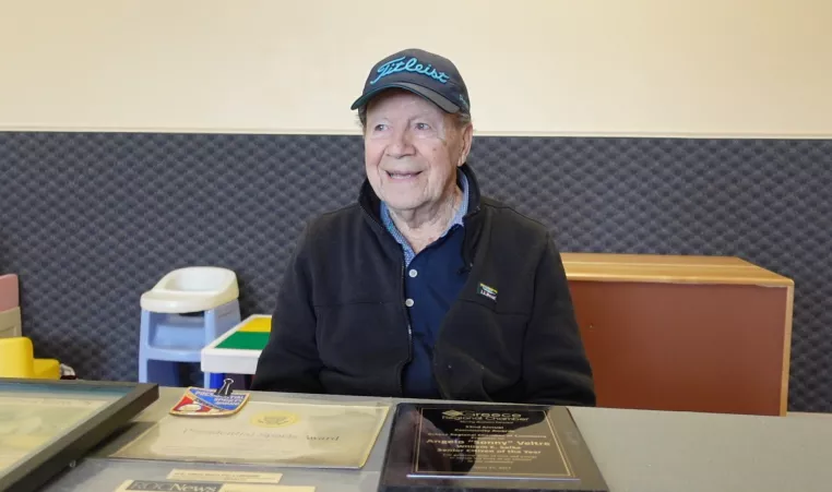 an older man sitting at a table