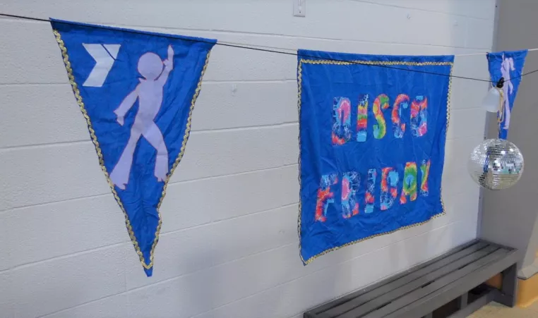 a banner for disco friday at the pool at the bay view family ymca