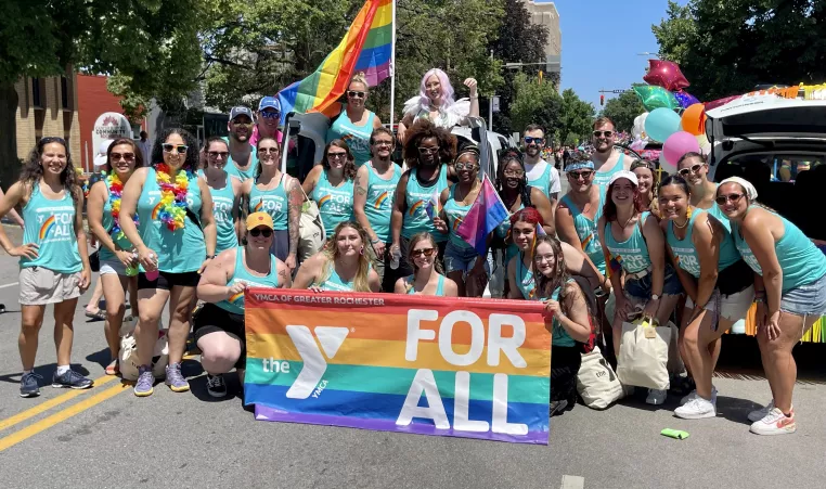 a group photo of ymca of greater rochester staff and volunteers during the 2022 rochester pride parade