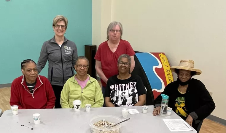 Karen Blank stops for picture with members of the Maplewood Family YMCA during a health talk in partnership with URMC and the YMCA