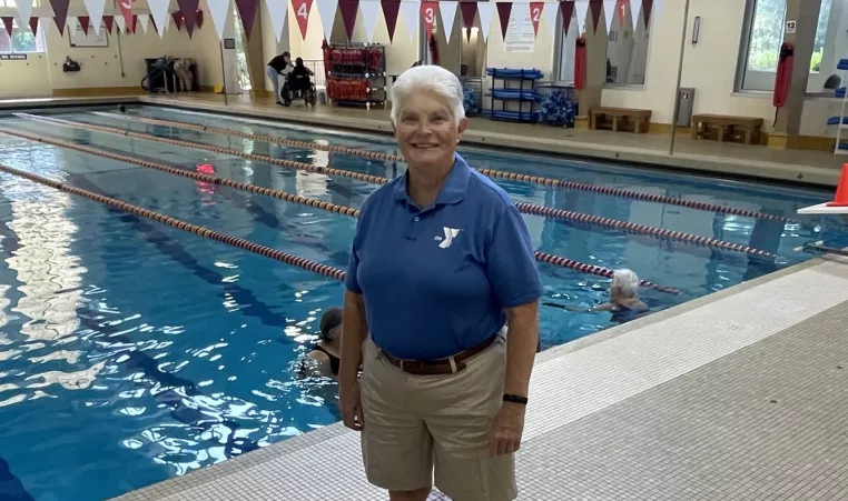 a photo of board member shannon standing in front of the northwest ymca lap pool