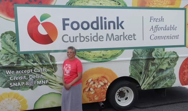 Flo from Foodlink standing in front of the Foodlink Curbside Market Food Truck