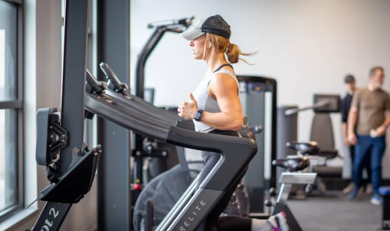 Woman running on a wind runner machine