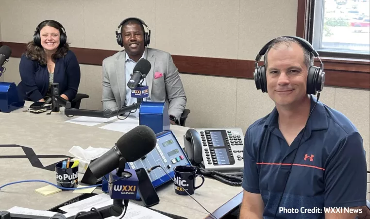 Pam Cowan, Chief Experience Officer, and Ernie Lamour, President & CEO, smile with Evan Dawson, host of Connections of WXXI News during a recent conversation for the show