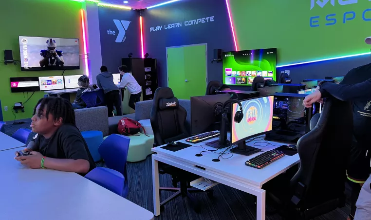 youth playing different video games inside the Metro Esports gaming lab at the Maplewood Family YMCA