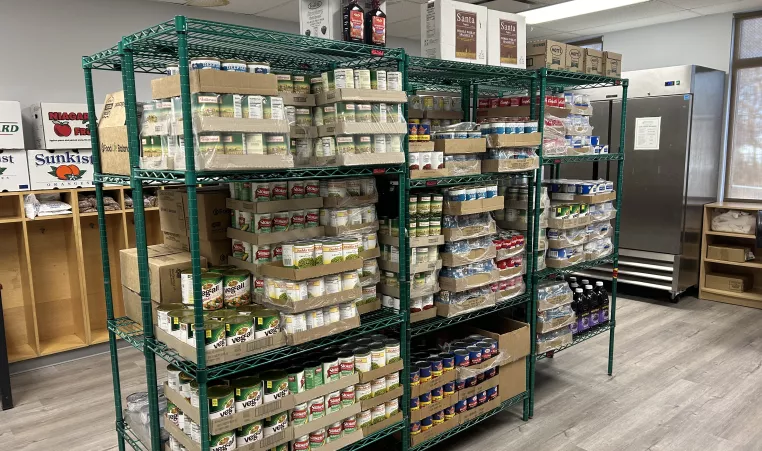 shelves stocked with canned goods at the Lewis Street YMCA Neighborhood Center food pantry opened in partnership with Foodlink