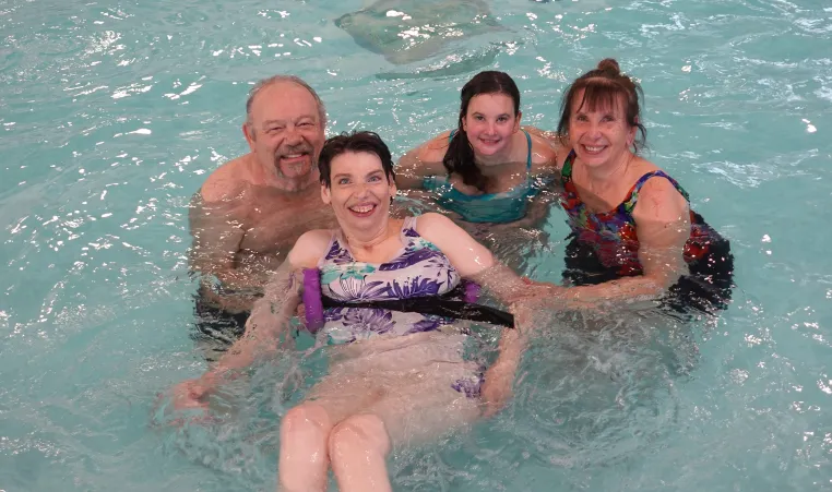 The Gagne family together in the pool posing for a group photo