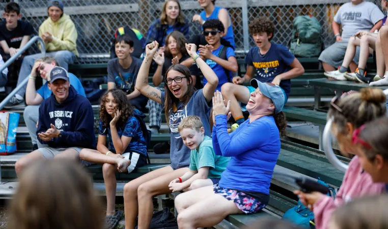 smiling and cheering campers and counselors