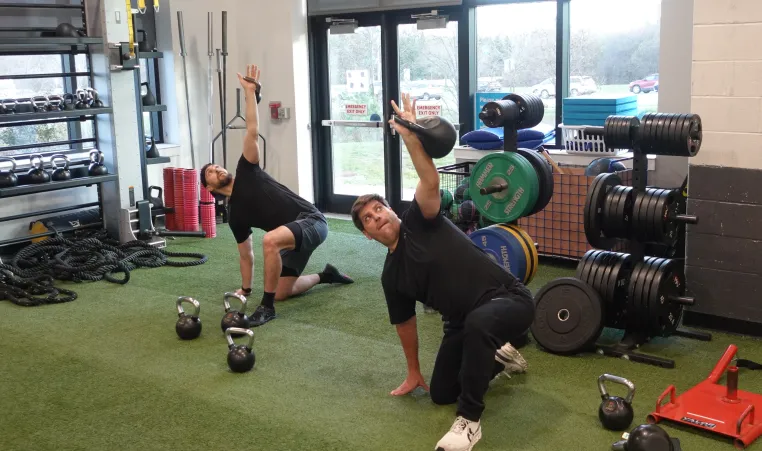 2 members doing a kettlebell workout at the Schottland Family YMCA