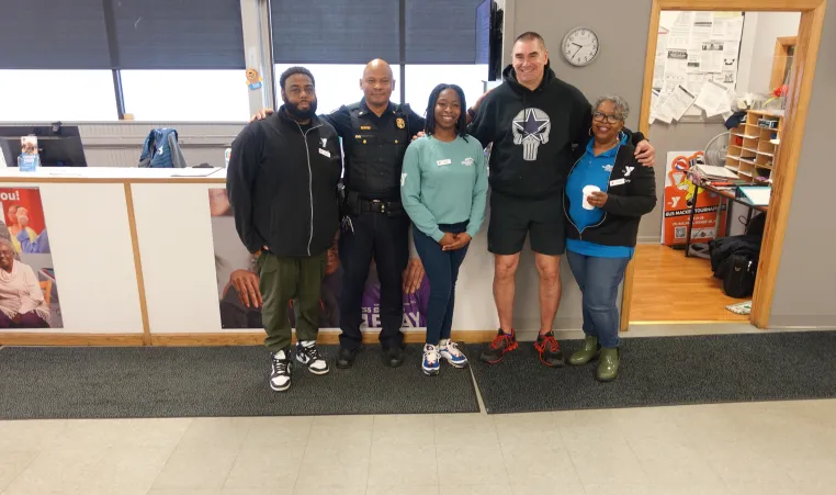 Rochester Police Department Officers stand with staff from the Thurston Road YMCA Neighborhood Center