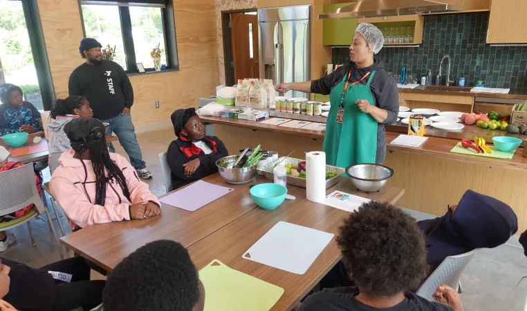 Power Scholars Academy campers learning in the kitchen at the Foodlink Farm