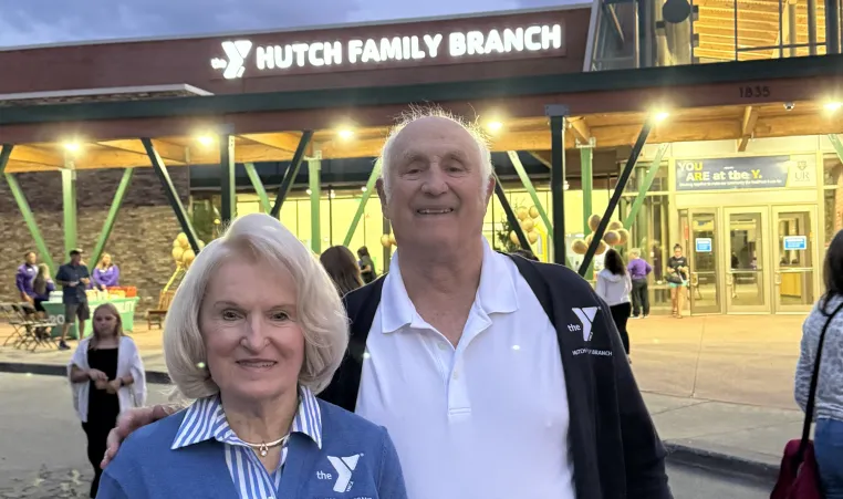 Ray and Erika Hutch stand in front of the newly named Hutch Family Branch in Penfield