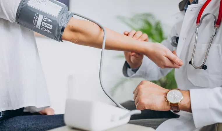 Patient having blood pressure taken by a psysician.