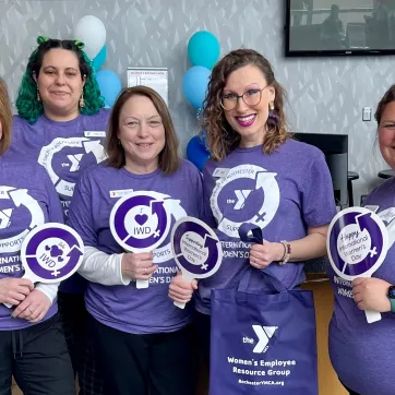 a photo of five ymca staff members who put together the international women's day vendor fair that was held at the westside family ymca