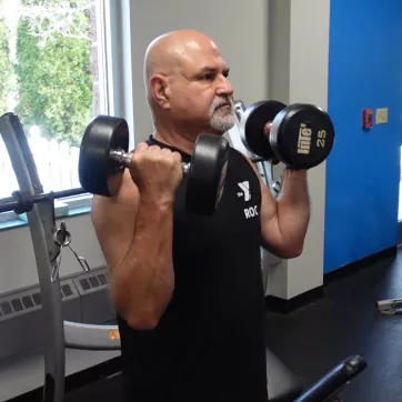 a ymca member exercising with dumbbells