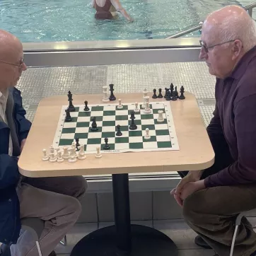 two men playing chess at the westside family ymca