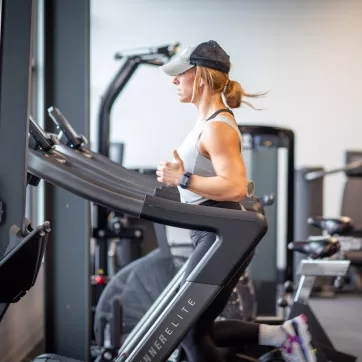 Woman running on a wind runner machine