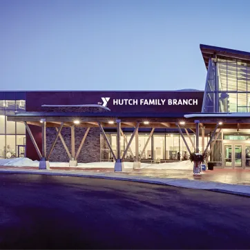 the outside of the current Eastside Family YMCA with the new name - Hutch Family YMCA - on the sign above the entrance