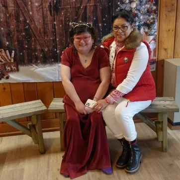 A member and a support staff sitting together at the Winter Wonderland Dance