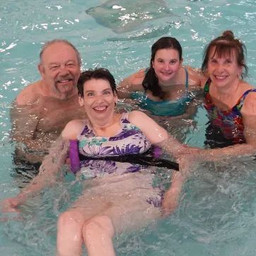 The Gagne family together in the pool posing for a group photo