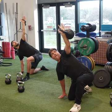 2 members doing a kettlebell workout at the Schottland Family YMCA