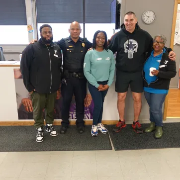 Rochester Police Department Officers stand with staff from the Thurston Road YMCA Neighborhood Center