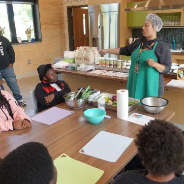 Power Scholars Academy campers learning in the kitchen at the Foodlink Farm