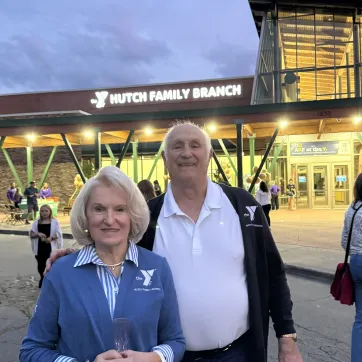 Ray and Erika Hutch stand in front of the newly named Hutch Family Branch in Penfield