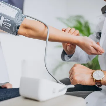 Patient having blood pressure taken by a psysician.