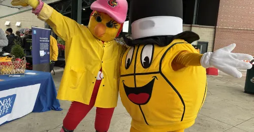 Gus Macker mascot the Macker Man poses for a picture with Mittsy from the Rochester Red Wings