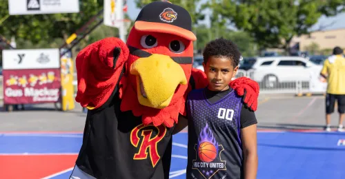 Spikes, the Red Wings mascot, poses with a young player