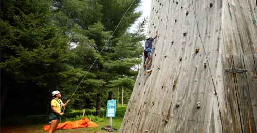 camper using rock wall