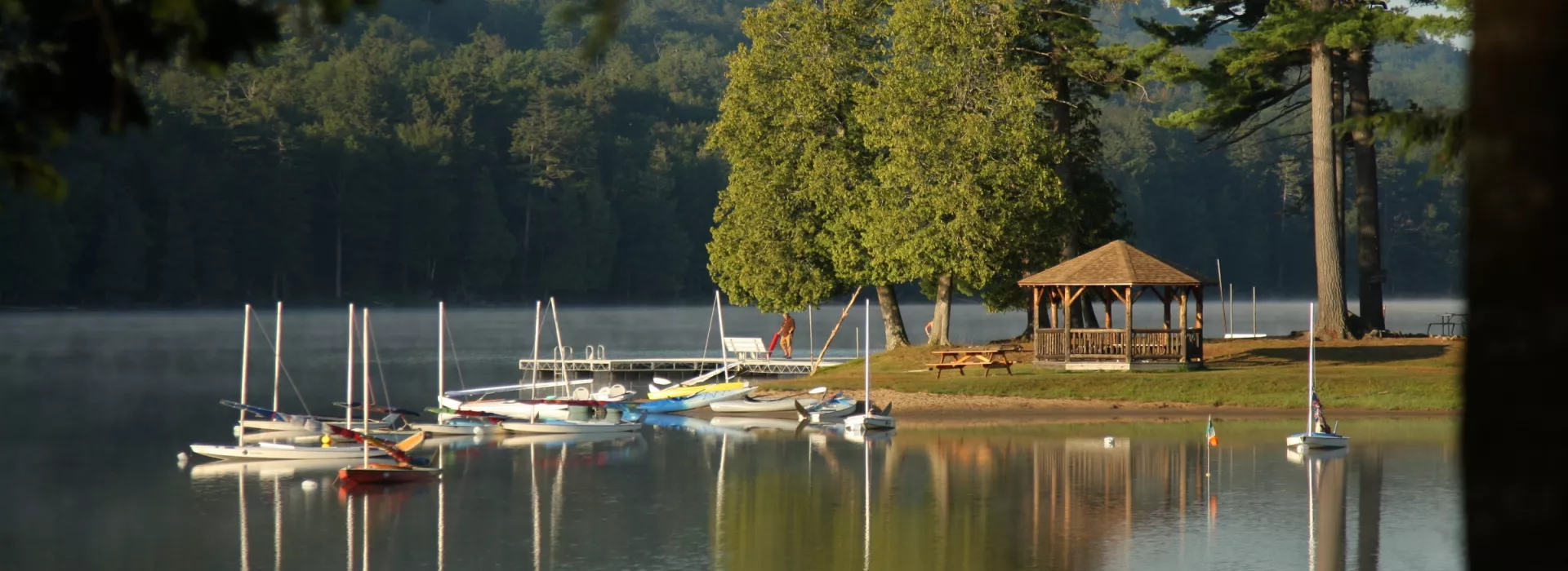 Photo of lake with sail boats and gazebo