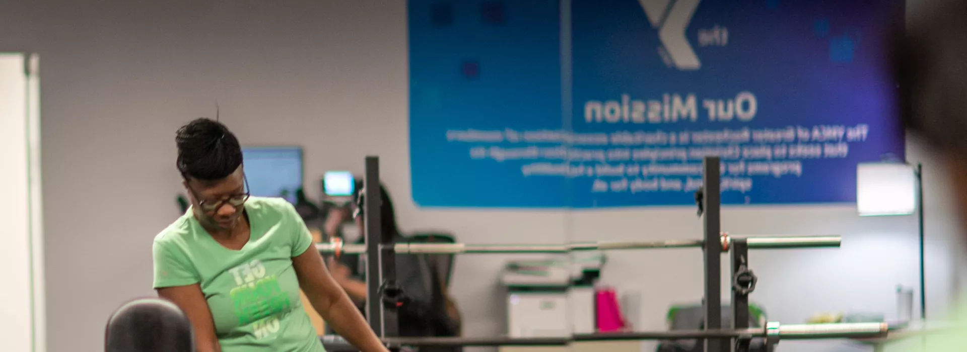 an african american woman doing exercises with a dumbbell