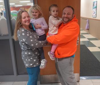 the alfano family of four poses for a picture at the northwest family ymca