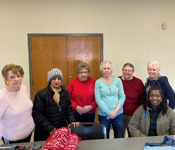 a group of members at the northwest family ymca pose for a picture during one of their handcrafting meetings
