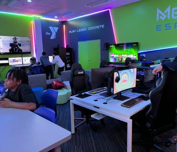 youth playing different video games inside the Metro Esports gaming lab at the Maplewood Family YMCA