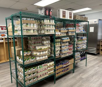 shelves stocked with canned goods at the Lewis Street YMCA Neighborhood Center food pantry opened in partnership with Foodlink