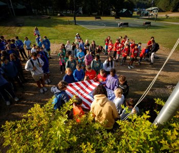 campers at YMCA Camp Gorham hold daily flag ceremony