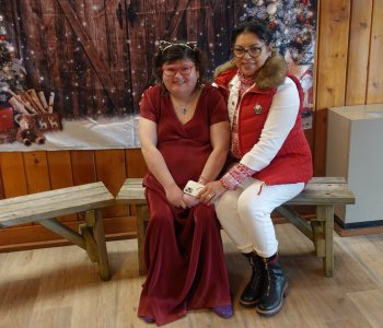 A member and a support staff sitting together at the Winter Wonderland Dance
