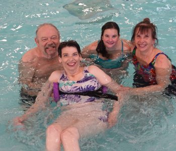 The Gagne family together in the pool posing for a group photo