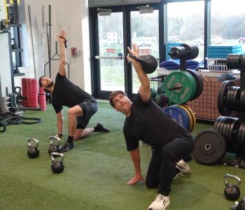 2 members doing a kettlebell workout at the Schottland Family YMCA