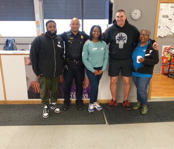 Rochester Police Department Officers stand with staff from the Thurston Road YMCA Neighborhood Center