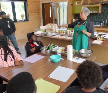 Power Scholars Academy campers learning in the kitchen at the Foodlink Farm