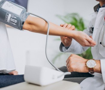 Patient having blood pressure taken by a psysician.